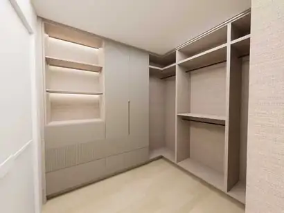 Rendering of a walk-in closet with lit shelves, tall doors and drawers beside open hanging sections