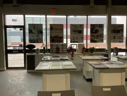 Showroom tables laid out with cabinet door samples under large front windows
