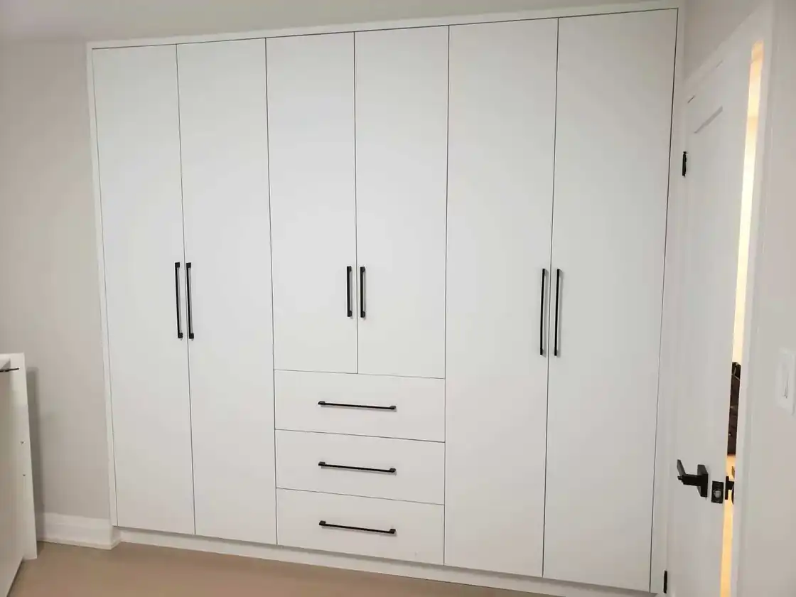 White built-in bedroom wardrobe with 6 tall doors and 3 drawers filling one wall