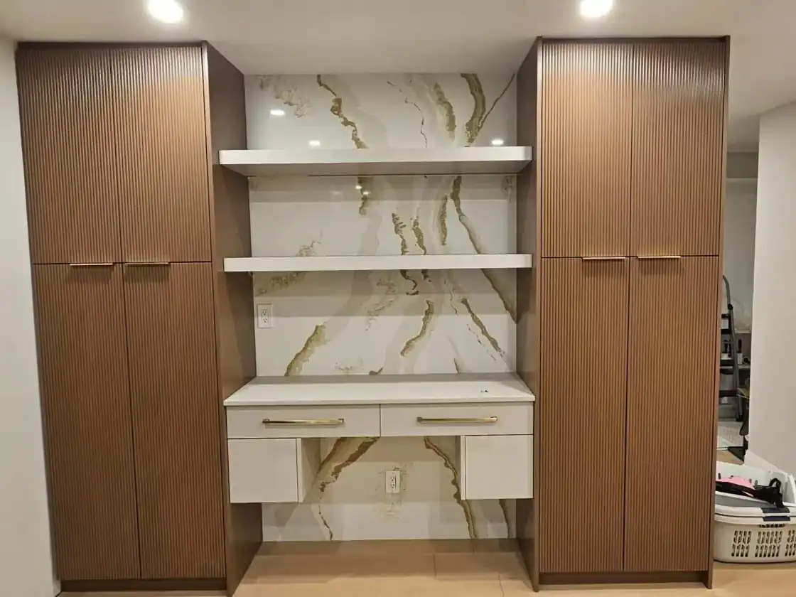 Two floor-to-ceiling pantry cabinets framing a counter-height coffee station with outlets and open shelves